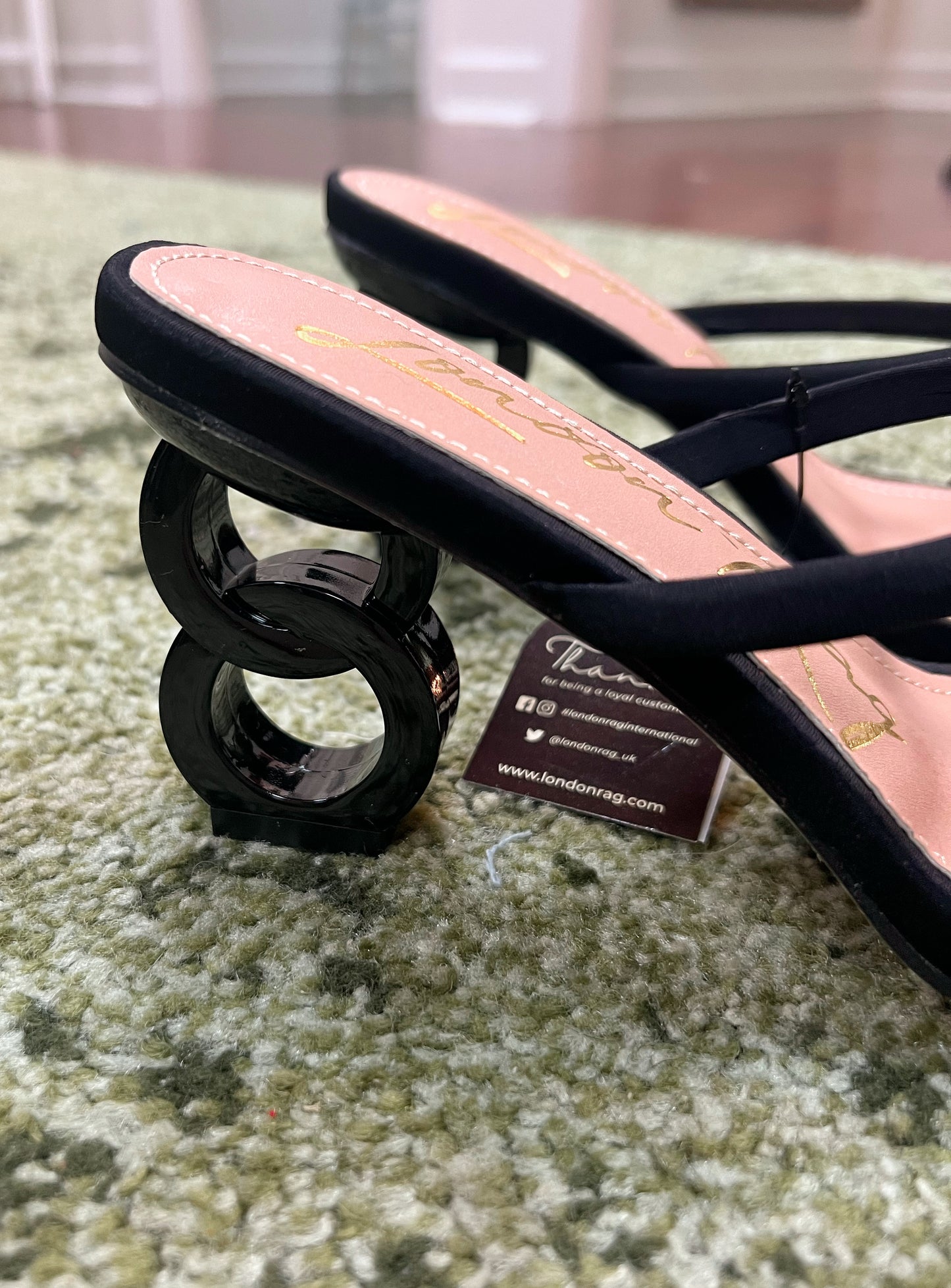 Black double strap mid-heeled sandal with a unique heel consisting of 2 interlocked circles