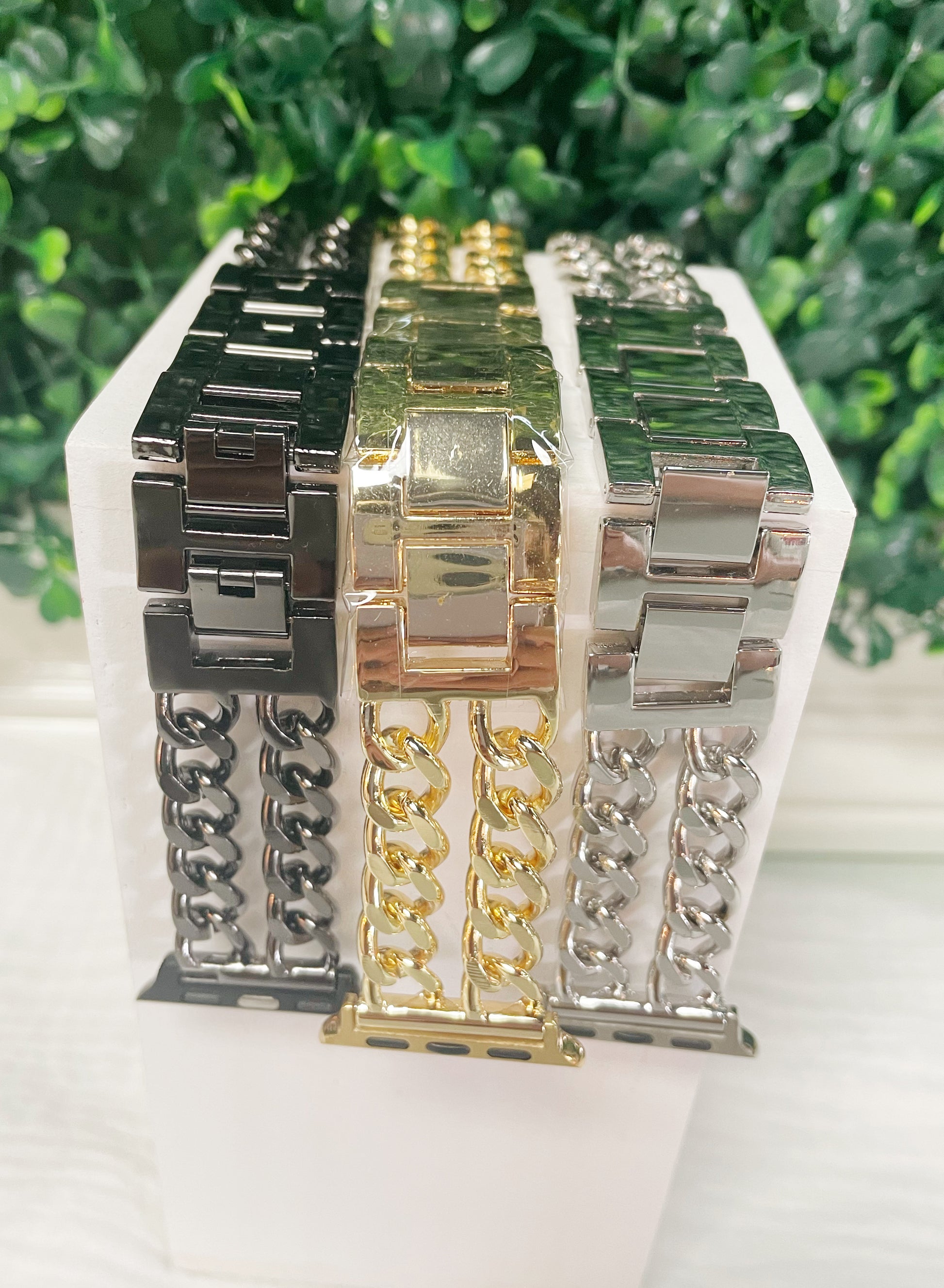Black, gold, and silver chain link apple watch bands