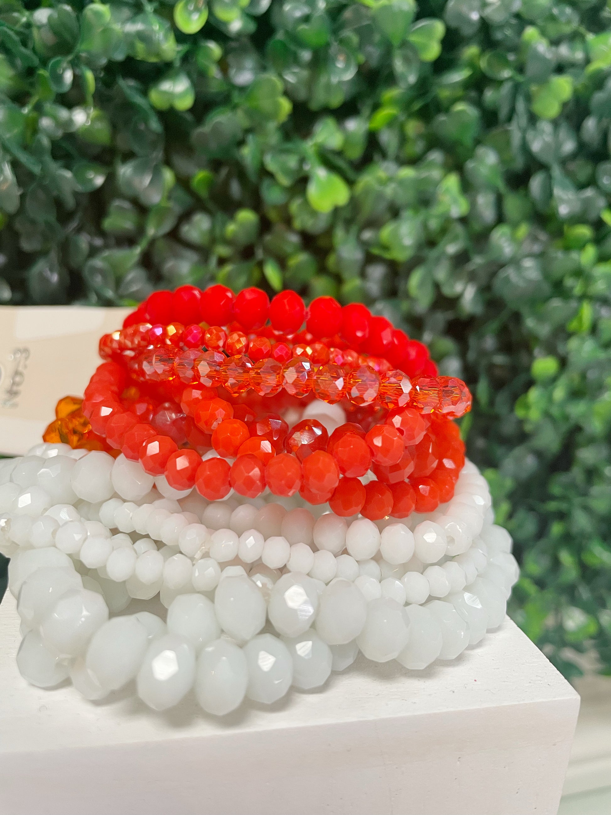 White and orange sets of stretchy bracelets
