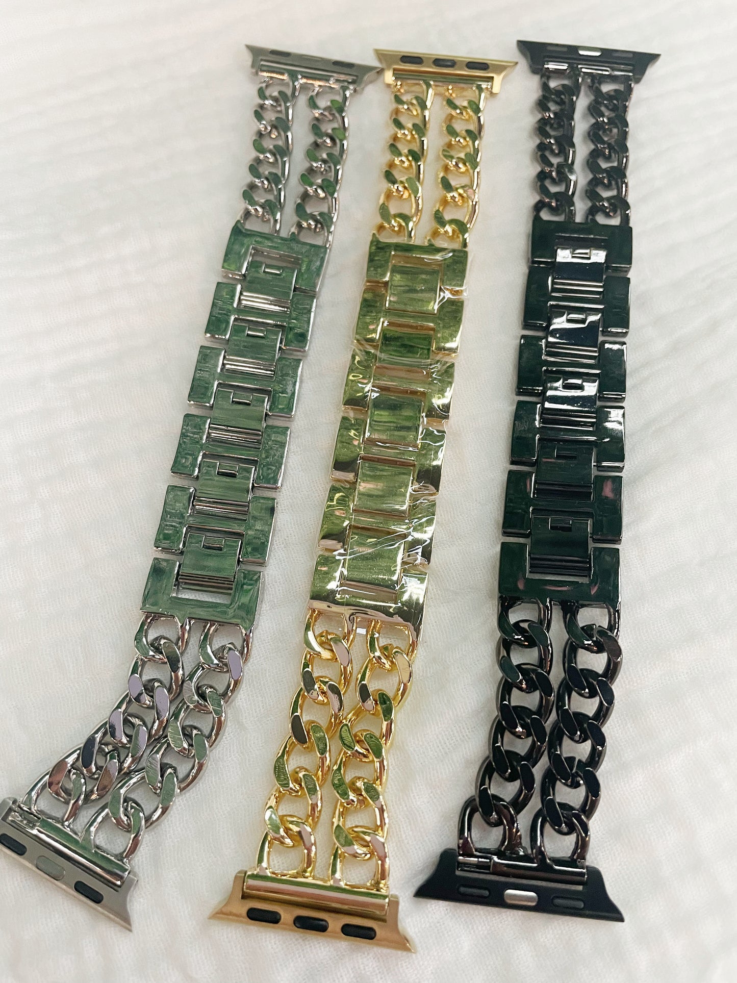 Black, gold, and silver chain link apple watch bands